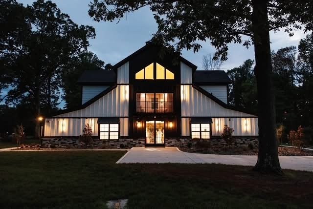 Milk and Honey Farms barn glowing at dusk